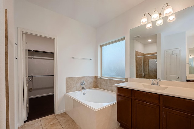 5339 Glenfield Spring Ln, Spring, TX 77389 - bathroom with a spacious closet, a stall shower, vanity, a bath, and tile patterned flooring
