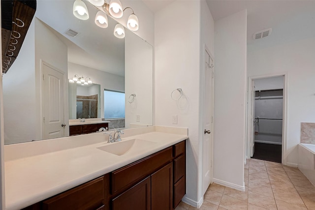 5339 Glenfield Spring Ln, Spring, TX 77389 - bathroom featuring vanity, a tub to relax in, a walk in closet, tile patterned flooring, and a shower