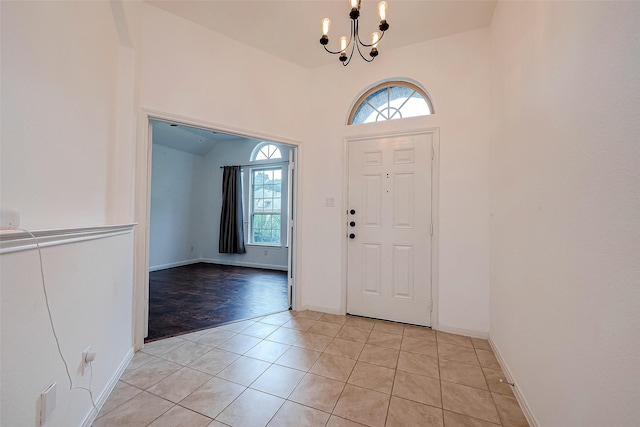 5339 Glenfield Spring Ln, Spring, TX 77389 - entryway with a chandelier, light tile patterned floors, baseboards, and lofted ceiling