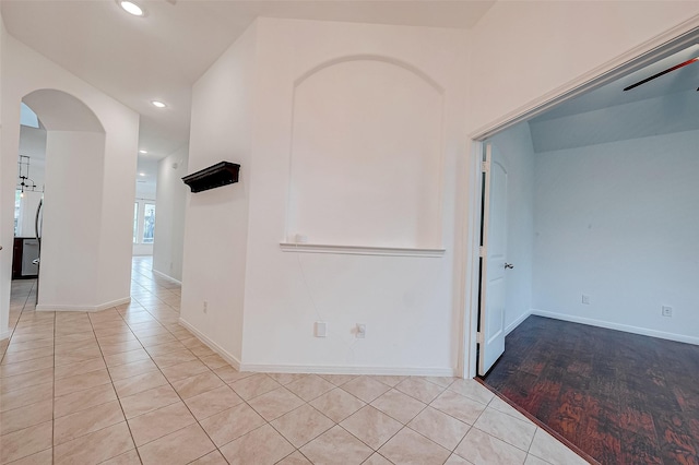 5339 Glenfield Spring Ln, Spring, TX 77389 - empty room featuring tile patterned floors, arched walkways, recessed lighting, and baseboards
