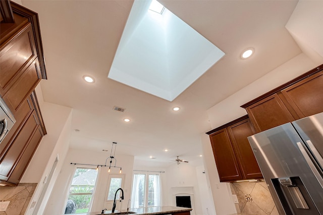 5339 Glenfield Spring Ln, Spring, TX 77389 - kitchen with a fireplace, recessed lighting, a sink, a ceiling fan, and decorative light fixtures