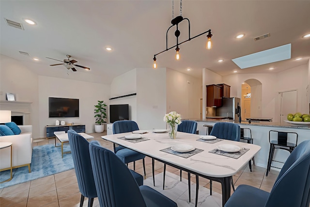 5339 Glenfield Spring Ln, Spring, TX 77389 - dining space featuring light tile patterned floors, ceiling fan, arched walkways, lofted ceiling, and recessed lighting