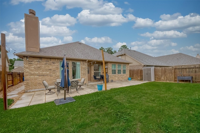 5339 Glenfield Spring Ln, Spring, TX 77389 - back of house featuring brick siding, a chimney, a patio, a shingled roof, and a storage shed