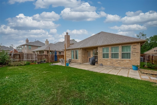 5339 Glenfield Spring Ln, Spring, TX 77389 - rear view of house with a shingled roof, brick siding, a patio, cooling unit, and a chimney
