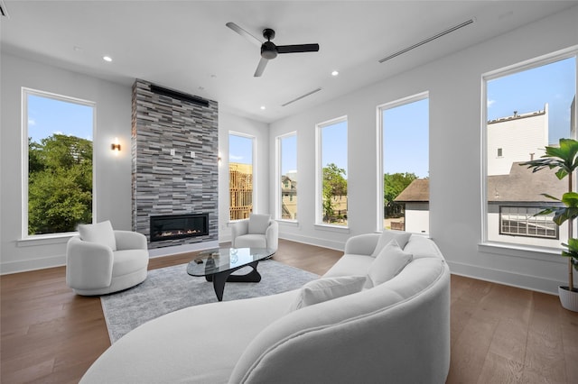 5705 Dolores St Unit B, Houston, TX 77057 - living room featuring a tiled fireplace, a ceiling fan, recessed lighting, and wood finished floors