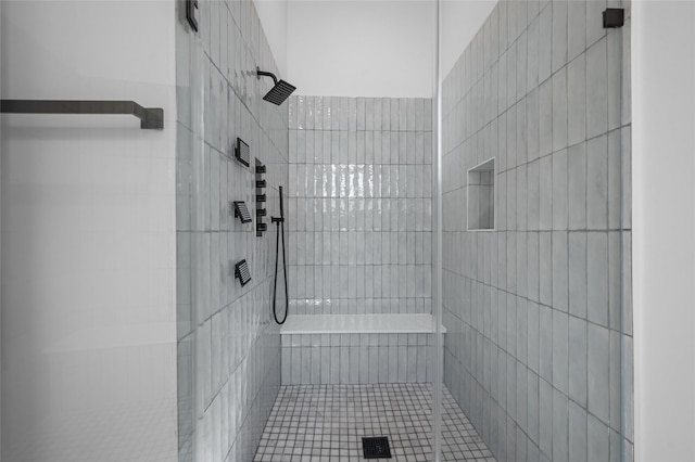5705 Dolores St Unit B, Houston, TX 77057 - full bath featuring a tile shower, tile walls, and tile patterned flooring