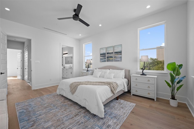 5705 Dolores St Unit B, Houston, TX 77057 - bedroom featuring light wood finished floors, multiple windows, recessed lighting, a ceiling fan, and ensuite bath