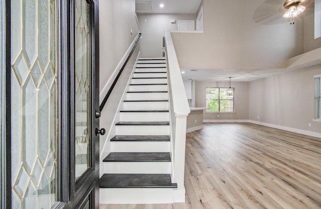 5238 Timber Quail Dr, Humble, TX 77346 - stairs with wood finished floors, ceiling fan, a towering ceiling, baseboards, and recessed lighting