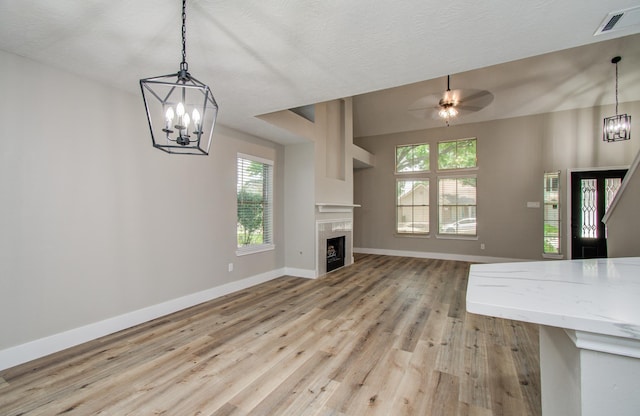 5238 Timber Quail Dr, Humble, TX 77346 - unfurnished living room with a chandelier, baseboards, and plenty of natural light