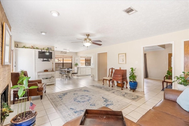 2639 Valley Field Dr, Sugar Land, TX 77479 - living room featuring light tile patterned floors, ceiling fan, and a textured ceiling