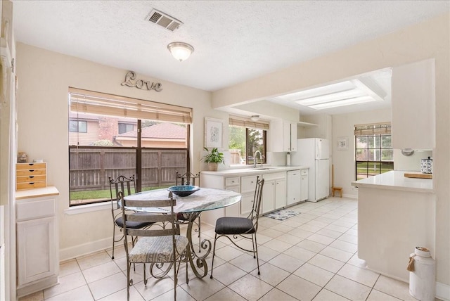 2639 Valley Field Dr, Sugar Land, TX 77479 - dining area featuring light tile patterned floors, baseboards, and a textured ceiling