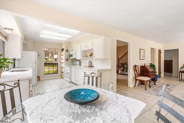 2639 Valley Field Dr, Sugar Land, TX 77479 - dining space with light tile patterned floors, stairway, and baseboards