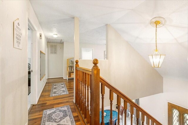 2639 Valley Field Dr, Sugar Land, TX 77479 - hallway with attic access, wood finished floors, and an upstairs landing