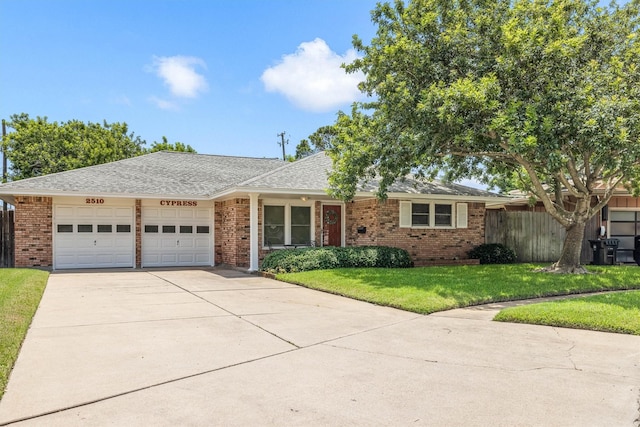 2510 Cypress Dr, Galveston, TX 77551 - ranch-style home with a garage, brick siding, concrete driveway, and a shingled roof