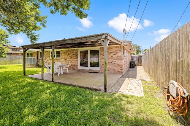 2510 Cypress Dr, Galveston, TX 77551 - back of property with brick siding, central air condition unit, and a patio