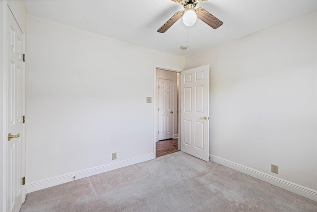 2510 Cypress Dr, Galveston, TX 77551 - unfurnished bedroom with light colored carpet, baseboards, and a ceiling fan