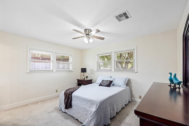 2510 Cypress Dr, Galveston, TX 77551 - bedroom featuring multiple windows, baseboards, and light colored carpet