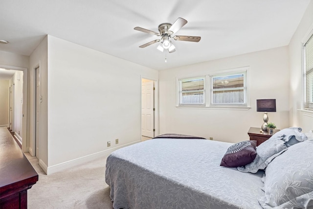 2510 Cypress Dr, Galveston, TX 77551 - bedroom with light carpet, multiple windows, a ceiling fan, and baseboards