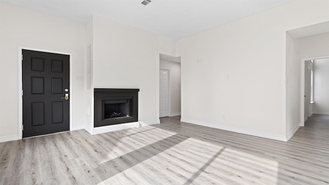 24006 Scrivener Ln, Katy, TX 77493 - unfurnished living room with wood finished floors, baseboards, and a fireplace