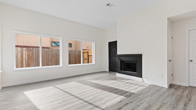 24006 Scrivener Ln, Katy, TX 77493 - unfurnished living room featuring wood finished floors, baseboards, and a fireplace