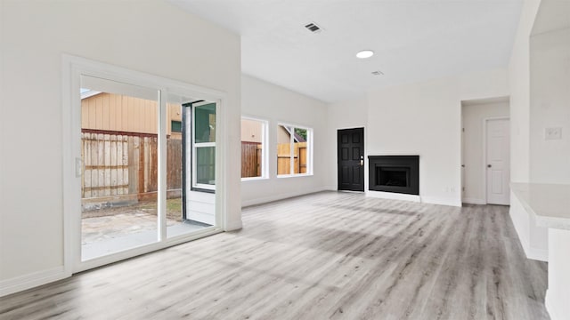 24006 Scrivener Ln, Katy, TX 77493 - unfurnished living room featuring light wood-style floors, baseboards, and a fireplace