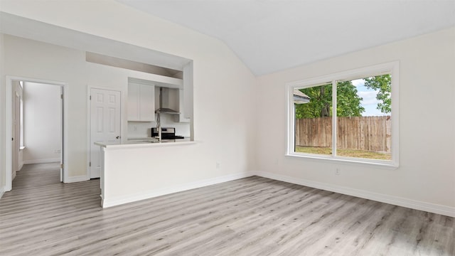 24006 Scrivener Ln, Katy, TX 77493 - unfurnished living room featuring light wood-type flooring, baseboards, and lofted ceiling