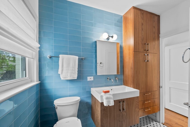 2101 Banks St, Houston, TX 77098 - bathroom featuring tile walls, toilet, and vanity
