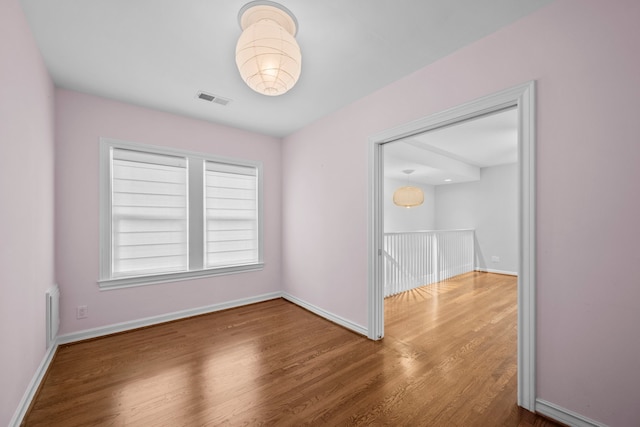 2101 Banks St, Houston, TX 77098 - spare room featuring wood finished floors and baseboards