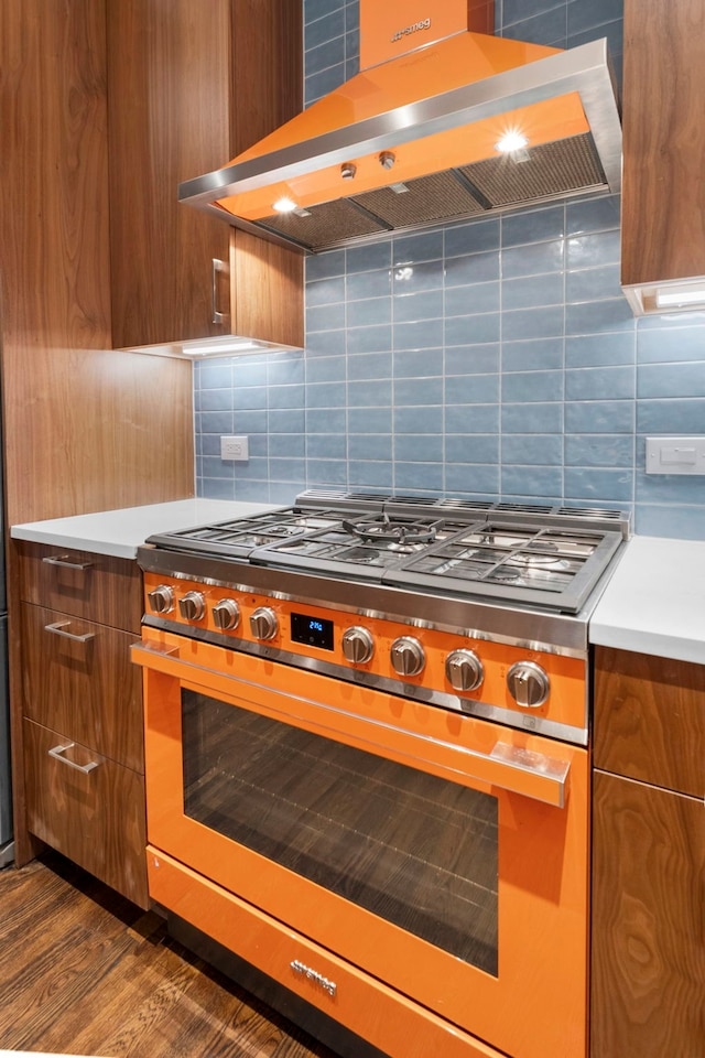 2101 Banks St, Houston, TX 77098 - kitchen with stainless steel range, island exhaust hood, modern cabinets, brown cabinets, and decorative backsplash