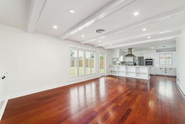 9643 Meadowcroft Dr, Houston, TX 77063 - unfurnished living room with healthy amount of natural light, beamed ceiling, dark wood-style flooring, a sink, and baseboards