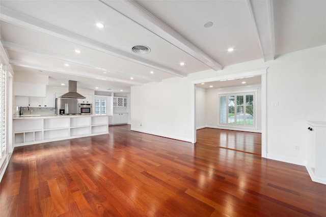 9643 Meadowcroft Dr, Houston, TX 77063 - unfurnished living room with beamed ceiling, wood finished floors, baseboards, and recessed lighting
