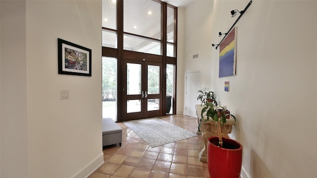 19823 Sunbridge Ln, Houston, TX 77094 - entrance foyer featuring french doors, a high ceiling, baseboards, light tile patterned flooring, and recessed lighting