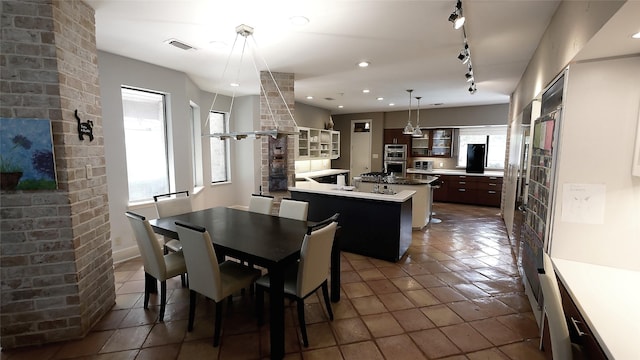 19823 Sunbridge Ln, Houston, TX 77094 - dining area with dark tile patterned floors, track lighting, and recessed lighting