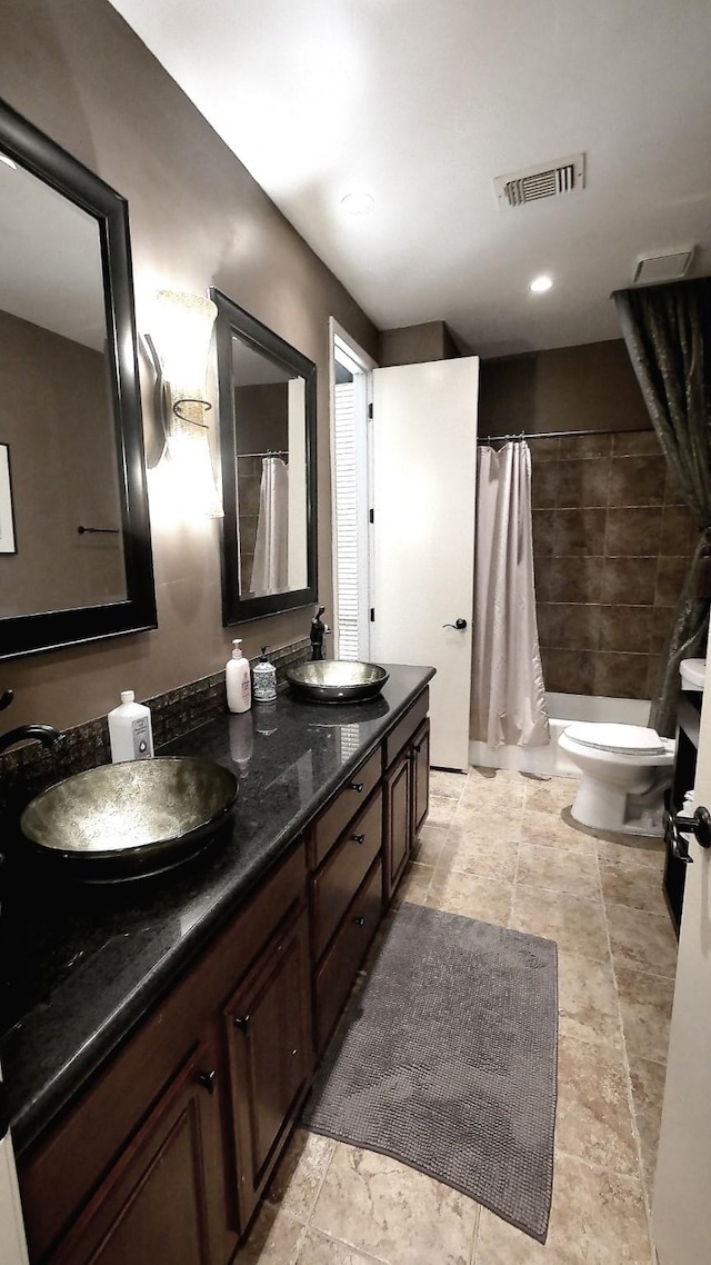 19823 Sunbridge Ln, Houston, TX 77094 - bathroom featuring curtained shower, double vanity, toilet, and stone finish flooring