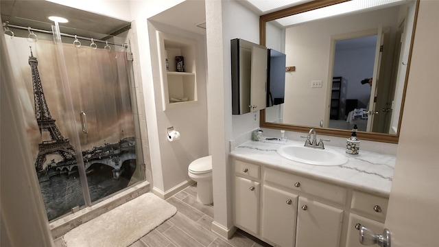 19823 Sunbridge Ln, Houston, TX 77094 - full bathroom with a stall shower, vanity, toilet, and wood tiled floors