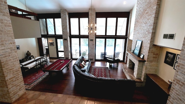 19823 Sunbridge Ln, Houston, TX 77094 - living room featuring a large fireplace, wood finished floors, and a towering ceiling