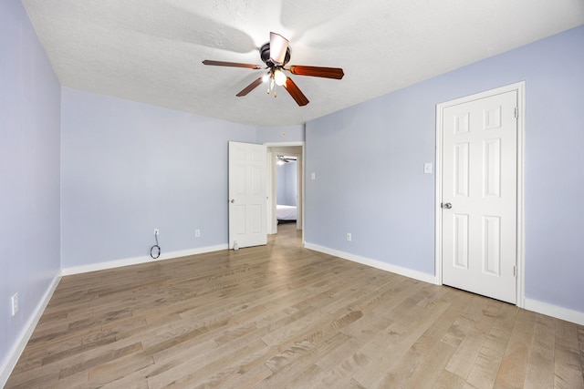 17823 Scenic Oaks Dr, Richmond, TX 77407 - unfurnished room with ceiling fan, light wood finished floors, baseboards, and a textured ceiling