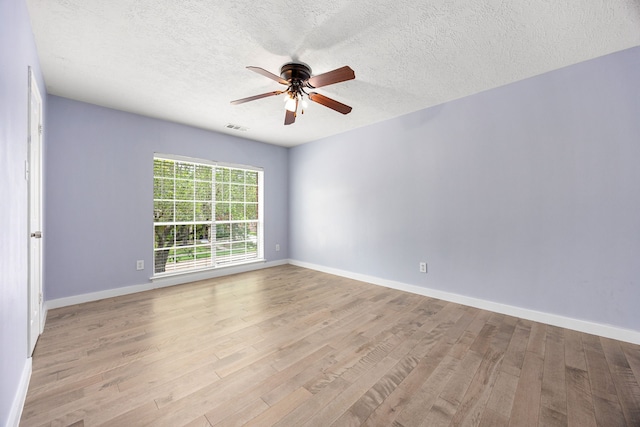17823 Scenic Oaks Dr, Richmond, TX 77407 - empty room with a ceiling fan, wood finished floors, baseboards, and a textured ceiling