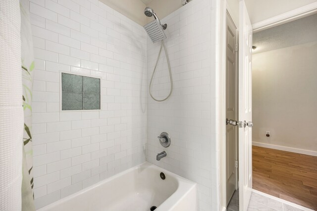 17823 Scenic Oaks Dr, Richmond, TX 77407 - full bath with shower / bath combo with shower curtain, baseboards, and wood finished floors