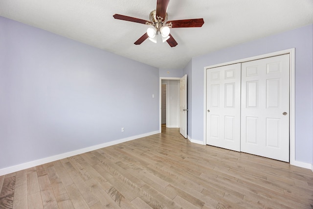 17823 Scenic Oaks Dr, Richmond, TX 77407 - unfurnished bedroom featuring baseboards, light wood-style floors, a closet, and ceiling fan