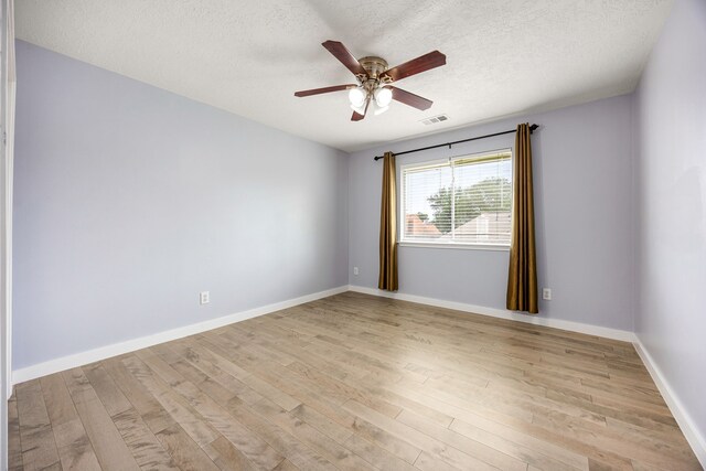 17823 Scenic Oaks Dr, Richmond, TX 77407 - unfurnished room featuring light wood finished floors, a ceiling fan, a textured ceiling, and baseboards