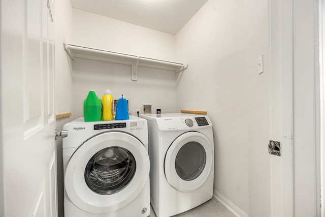 17823 Scenic Oaks Dr, Richmond, TX 77407 - laundry area with washer and clothes dryer and baseboards