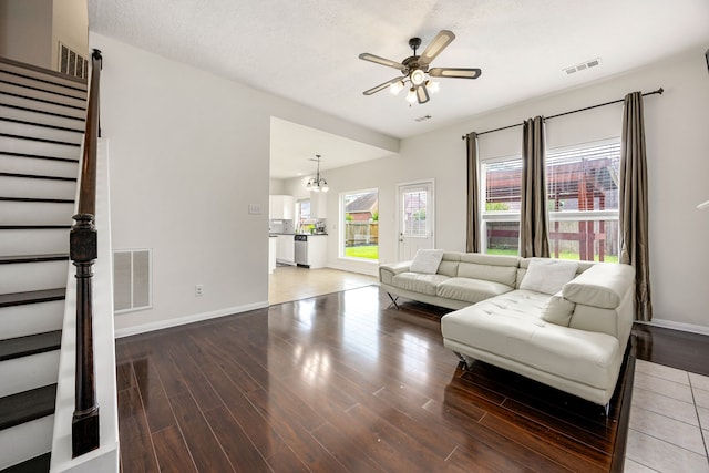 17823 Scenic Oaks Dr, Richmond, TX 77407 - living area with stairway, a ceiling fan, light wood finished floors, and baseboards