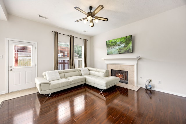 17823 Scenic Oaks Dr, Richmond, TX 77407 - living area featuring a ceiling fan, plenty of natural light, a tile fireplace, and wood finished floors