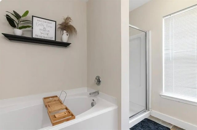 1609 Palcio Real Dr, Houston, TX 77047 - bathroom with a shower stall, a bath, and baseboards
