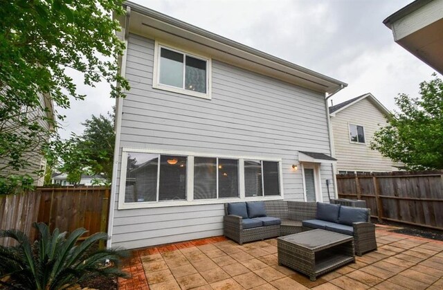 1609 Palcio Real Dr, Houston, TX 77047 - back of house featuring a patio, an outdoor hangout area, and a fenced backyard