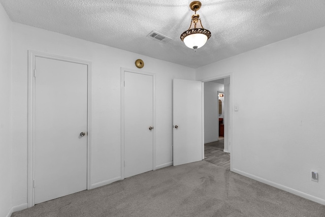 808 Riverside Dr, Alvin, TX 77511 - unfurnished bedroom featuring carpet flooring, a textured ceiling, and baseboards