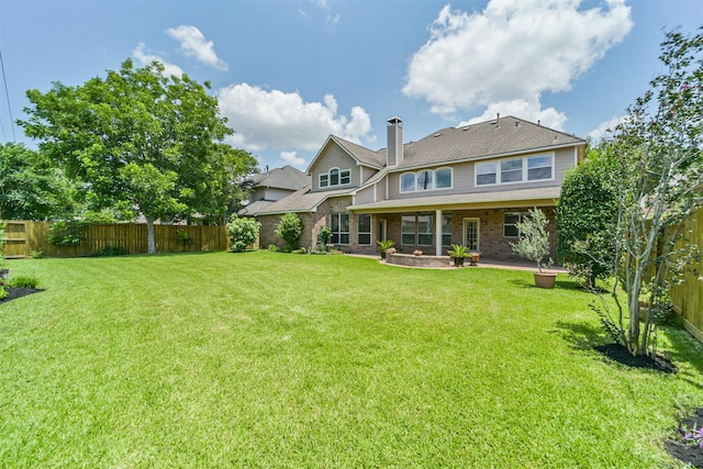 7319 Fair Meadow Ln, Katy, TX 77494 - back of house with a chimney, brick siding, and a patio