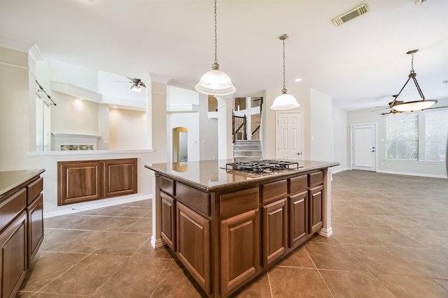 7319 Fair Meadow Ln, Katy, TX 77494 - kitchen featuring ceiling fan, stainless steel gas stovetop, open floor plan, a center island, and hanging light fixtures