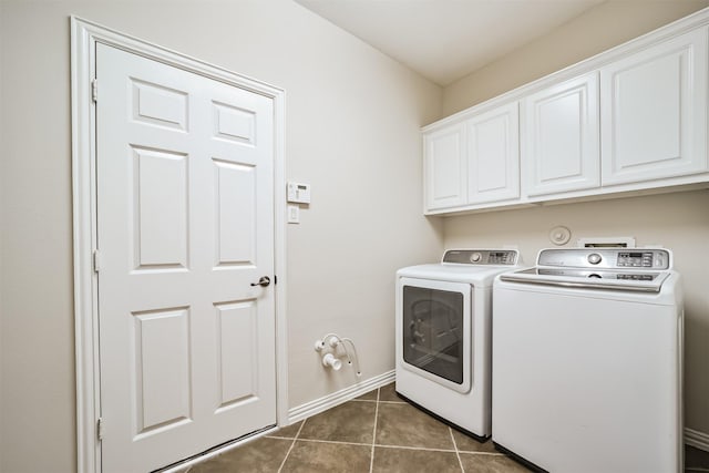 7319 Fair Meadow Ln, Katy, TX 77494 - laundry area featuring cabinet space, washing machine and dryer, dark tile patterned floors, and baseboards